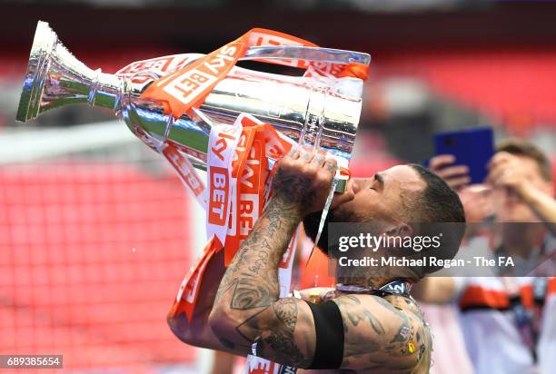 Kyle Vassell of Blackpool celebrates victory and promotion with the trophy after the Sky Bet League Two Playoff Final between Blackpool and Exeter...