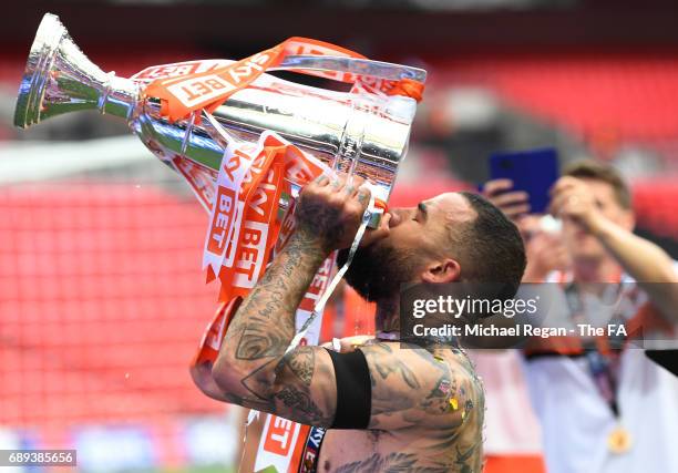 Kyle Vassell of Blackpool celebrates victory and promotion with the trophy after the Sky Bet League Two Playoff Final between Blackpool and Exeter...