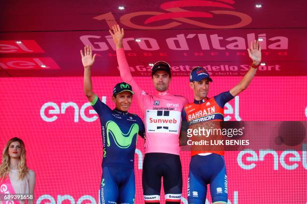 The winner of the 100th Giro d'Italia, Tour of Italy cycling race, Netherlands' Tom Dumoulin of team Sunweb celebrates on the podium with Italy's...