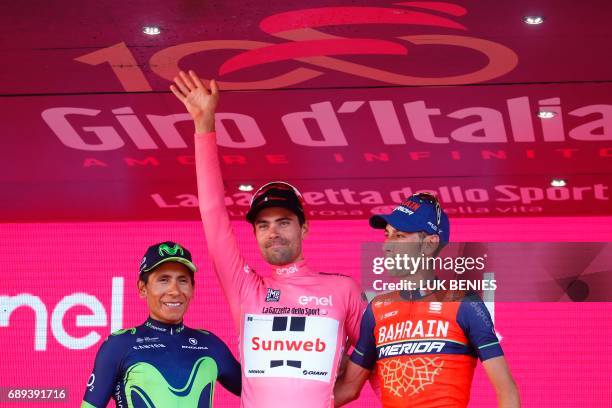 The winner of the 100th Giro d'Italia, Tour of Italy cycling race, Netherlands' Tom Dumoulin of team Sunweb celebrates on the podium with Italy's...