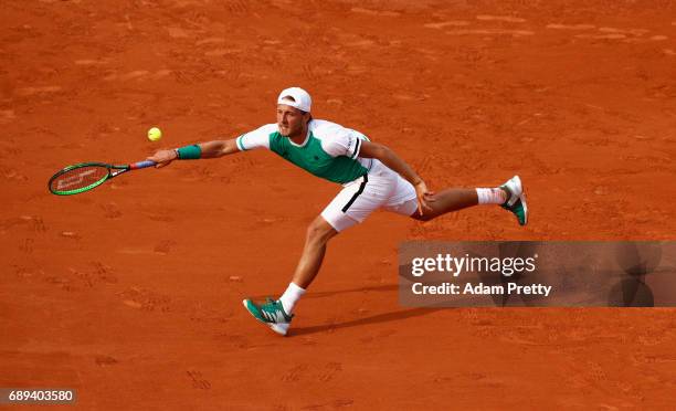 Lucas Pouille of France plays a forehand during the mens singles first round match against Julien Benneteau of France on day one of the 2017 French...