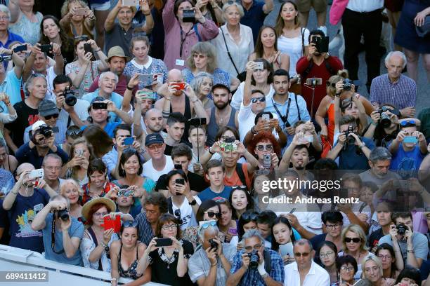 Fans watch celebrities arriving for the Closing Ceremony of the 70th annual Cannes Film Festival at Palais des Festivals on May 28, 2017 in Cannes,...