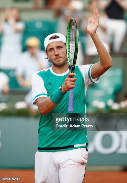 Lucas Pouille of France celebrates victory following victory over Julien Benneteau of France on day one of the 2017 French Open at Roland Garros on...