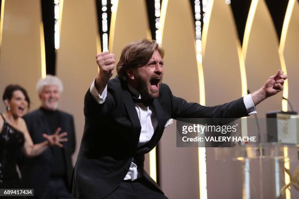 Swedish director Ruben Ostlund asks the audience to roar after he was awarded with the Palme d'Or for the film 'The Square' on May 28, 2017 during...