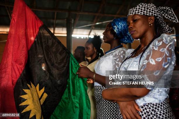Woman holds a Biafran flag during a service at the St. Martin Catholic of Tours Church on May 28, 2017 in the Aba-South district in Aba. The Nigerian...