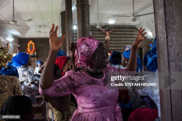Women dance during a service at the St. Martin of Tours Catholic Church in the Aba-South district in Aba on May 28, 2017. The Nigerian civil wars...