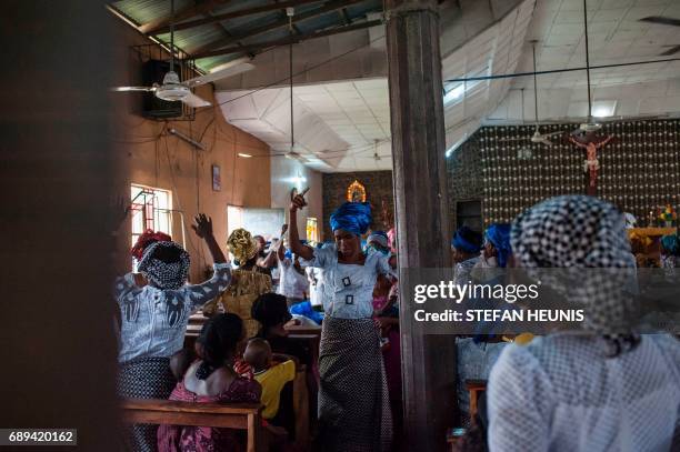 Women dance during a service at the St. Martin of Tours Catholic Church in the Aba-South district in Aba on May 28, 2017. The Nigerian civil wars...