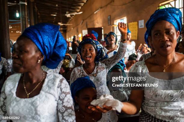 Women dance and sing during a service at the St. Martin of Tours Catholic Church in the Aba-South district in Aba on May 28, 2017. The Nigerian civil...