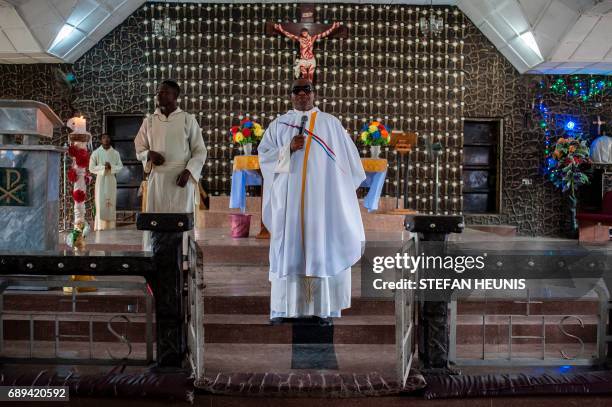 Father Charles Ubawuike preaches during a service at the St. Martin of Tours Catholic Church in the Aba-South district in Aba on May 28, 2017. The...