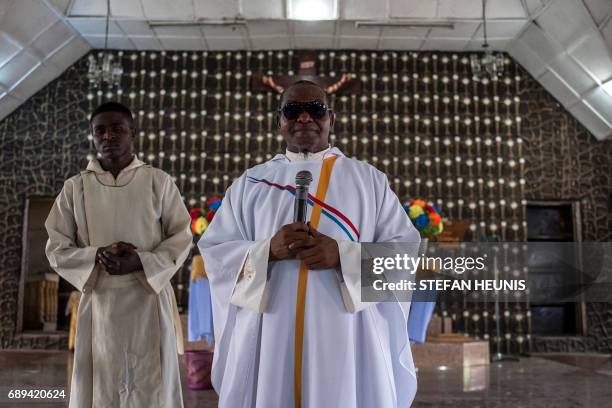Father Charles Ubawuike preaches during a service at the St. Martin of Tours Catholic Church in the Aba-South district in Aba on May 28, 2017. The...
