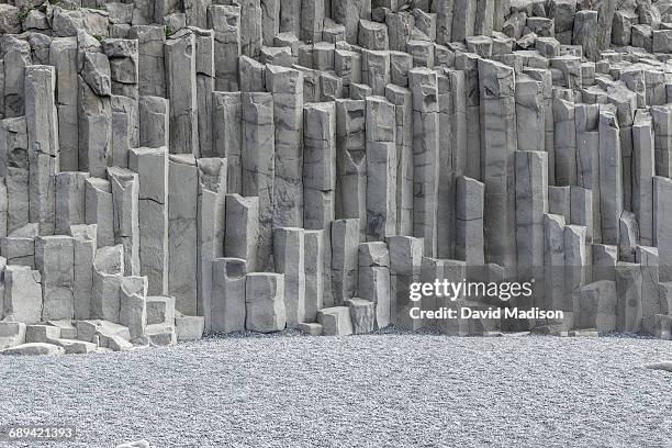 basalt columns and black sand beach. - basalt stock pictures, royalty-free photos & images