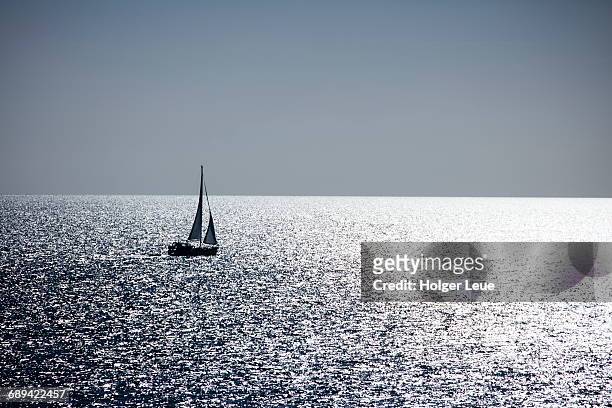 silhouette of sailboat in the kattegat sea - kattegat stock-fotos und bilder