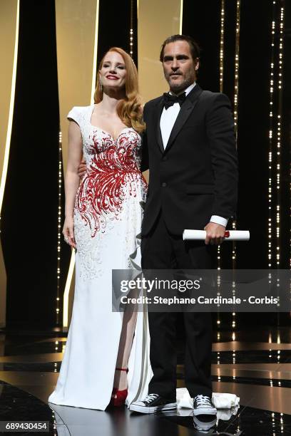 Joaquin Phoenix poses with jury member Jessica Chastain on the stage after receiving the award for Best Actor for his part in the movie "You Were...