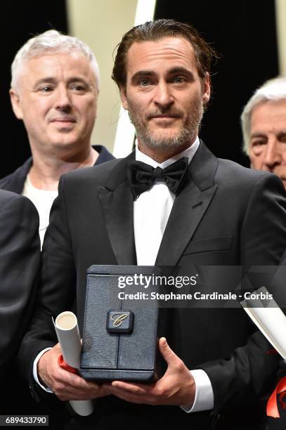 Joaquin Phoenix poses on stage with the award for Best Actor for his part in the movie "You Were Never Really Here" attends the Closing Ceremony...