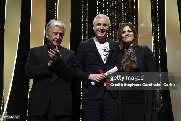 Robin Campillo poses on the stage with jury member Agnes Jaoui and director Costa-Gavras after receiving the Grand Prix for the movie "120 Beats Per...