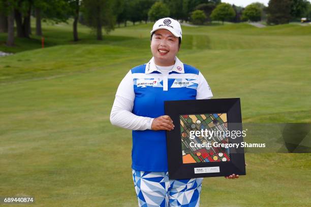 Shanshan Feng of China poses with the championship trophy after winning the LPGA Volvik Championship on May 28, 2017 at Travis Pointe Country Club...