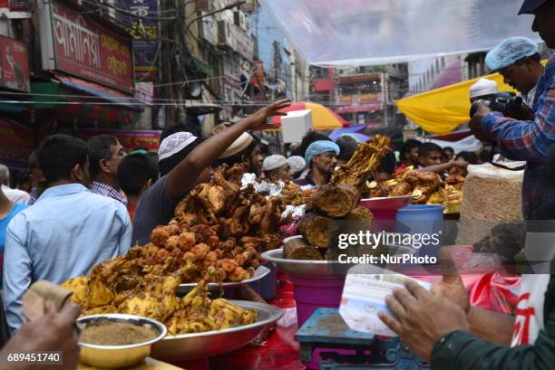 Vendor waits with foods for customers in the traditional Ifter market at Chalk Bazar as the first day of the Holy month Ramadan in Dhaka, Bangladesh....