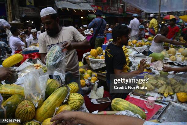 Vendor waits with foods for customers in the traditional Ifter market at Chalk Bazar as the first day of the Holy month Ramadan in Dhaka, Bangladesh....