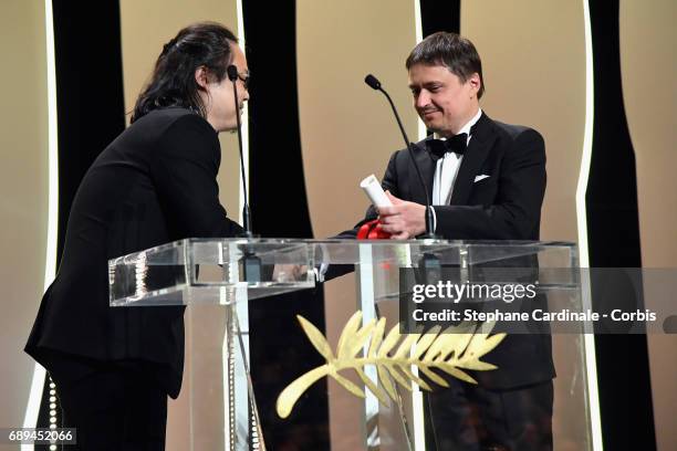 President of the Short Films and Cinefondation jury Cristian Mungiu hands over the award for Best Short for "A Gentle Night" to director Qiu Yang...