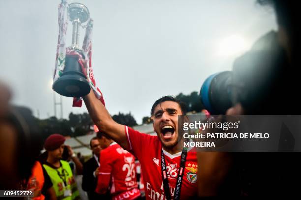 Benfica's Argentine midfielder Eduardo Salvio celebrates with the trophy at the end of the Portugal's Cup final football match SL Benfica vs Vitoria...