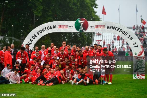 Benfica's team poses for a photo with the trophy at the end of the Portugal's Cup final football match SL Benfica vs Vitoria SC at Jamor stadium in...