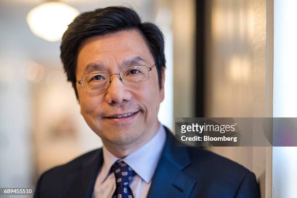 Kai-fu Lee, founder and chief executive officer of Sinovation Ventures, stands for a photographer after a Bloomberg Technology interview in San...