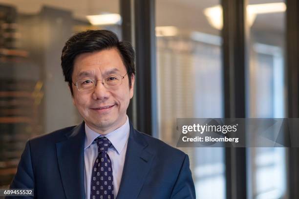 Kai-fu Lee, founder and chief executive officer of Sinovation Ventures, stands for a photographer after a Bloomberg Technology interview in San...