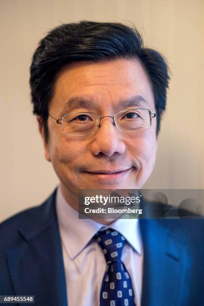 Kai-fu Lee, founder and chief executive officer of Sinovation Ventures, stands for a photographer after a Bloomberg Technology interview in San...