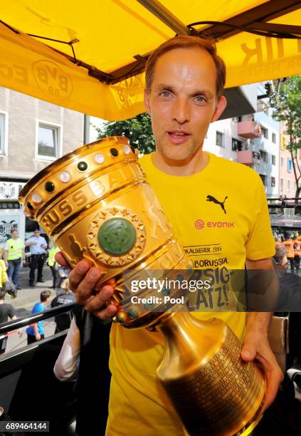 Trainer Thomas Tuchel of Borussia Dortmund lifts the DFB Cup trophy as the team celebrates during a winner's parade at Borsigplatz on May 28, 2017 in...