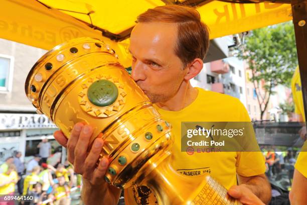 Trainer Thomas Tuchel of Borussia Dortmund lifts the DFB Cup trophy as the team celebrates during a winner's parade at Borsigplatz on May 28, 2017 in...