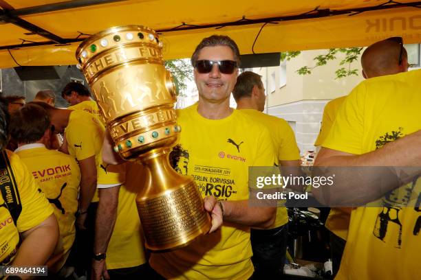 Manager Michael Zorc of Borussia Dortmund lifts the DFB Cup trophy as the team celebrates during a winner's parade at Borsigplatz on May 28, 2017 in...