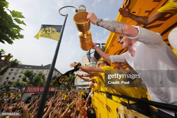 Marco Reus of Borussia Dortmund lifts the DFB Cup trophy as the team celebrates during a winner's parade at Borsigplatz on May 28, 2017 in Dortmund,...