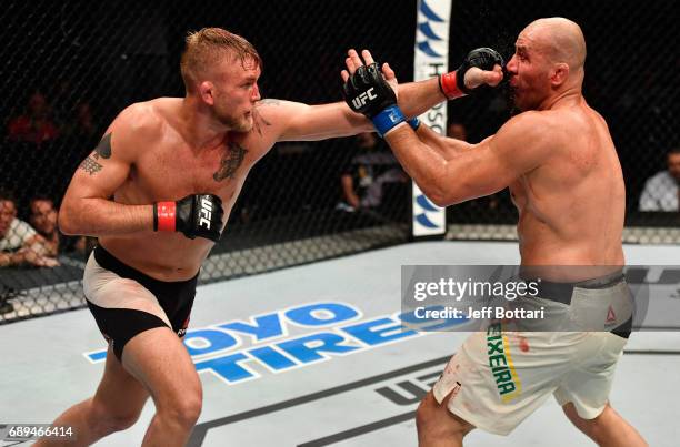 Alexander Gustafsson punches Glover Teixeira in their light heavyweight fight during the UFC Fight Night event at the Ericsson Globe Arena on May 28,...