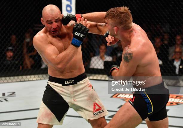 Alexander Gustafsson punches Glover Teixeira in their light heavyweight fight during the UFC Fight Night event at the Ericsson Globe Arena on May 28,...