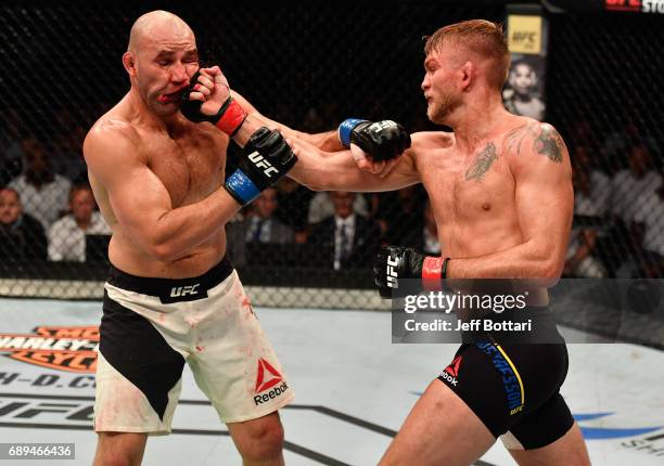 Alexander Gustafsson punches Glover Teixeira in their light heavyweight fight during the UFC Fight Night event at the Ericsson Globe Arena on May 28,...