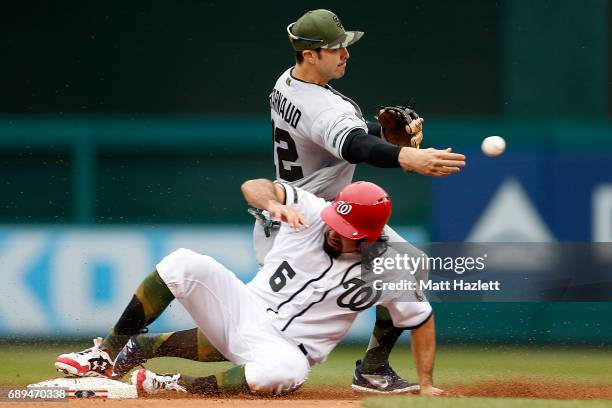 Chase d'Arnaud of the San Diego Padres attempts to turn a double play over Anthony Rendon of the Washington Nationals for the second out of the...