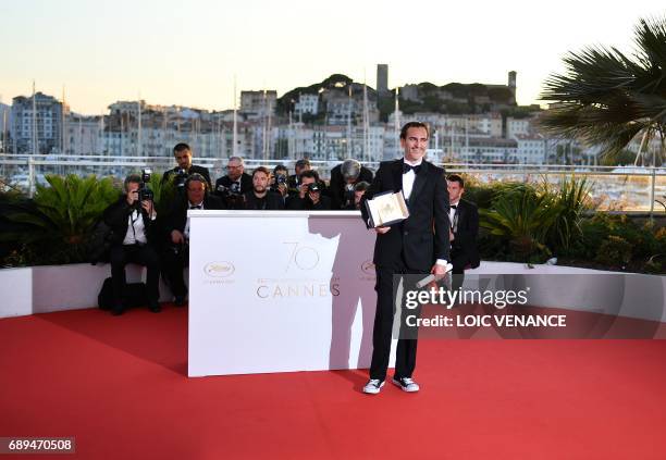 Actor Joaquin Phoenix poses on May 28, 2017 during a photocall after he won the Best Actor Prize for 'You Were Never Really Here' at the 70th edition...