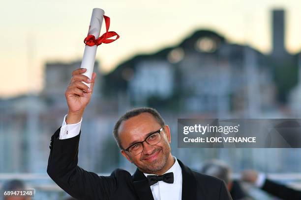 Russian director Andrey Zvyagintsev poses on May 28, 2017 during a photocall after he won the Jury Prize for his film 'Loveless' at the 70th edition...