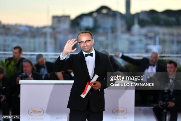 Russian director Andrey Zvyagintsev poses on May 28, 2017 during a photocall after he won the Jury Prize for his film 'Loveless' at the 70th edition...