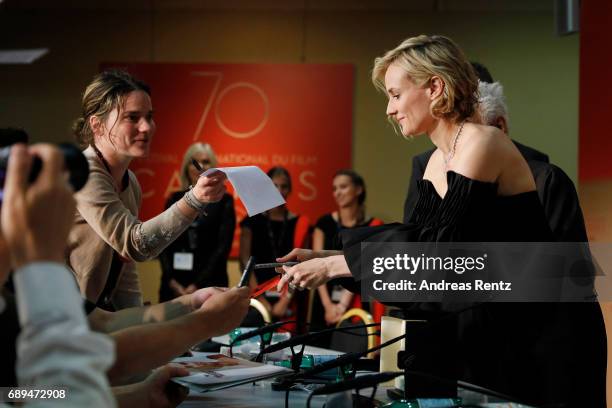 Diane Kruger, winner of the award for best actress for her part in the movie "In The Fade" signs autographs as she attends the Palme D'Or winner...