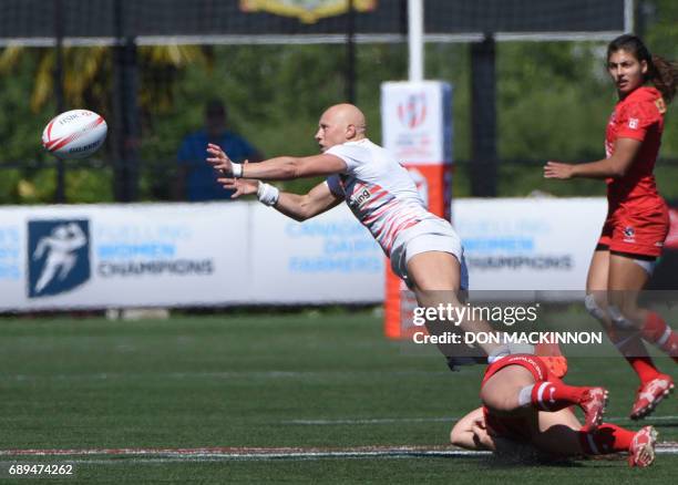 Ashley Steacy of Canada tackels Heather Fisher of England on day two of HSBC Canada WomenÕs Sevens Rugby action at Westhills Stadium in Langford,...