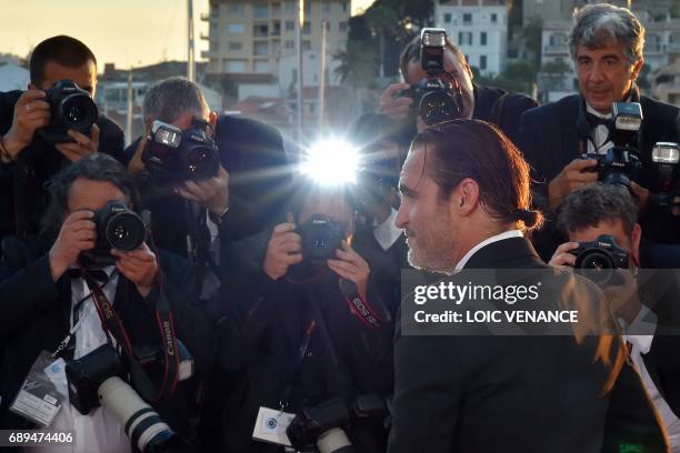 Actor Joaquin Phoenix poses on May 28, 2017 during a photocall after he won the Best Actor Prize for 'You Were Never Really Here' at the 70th edition...