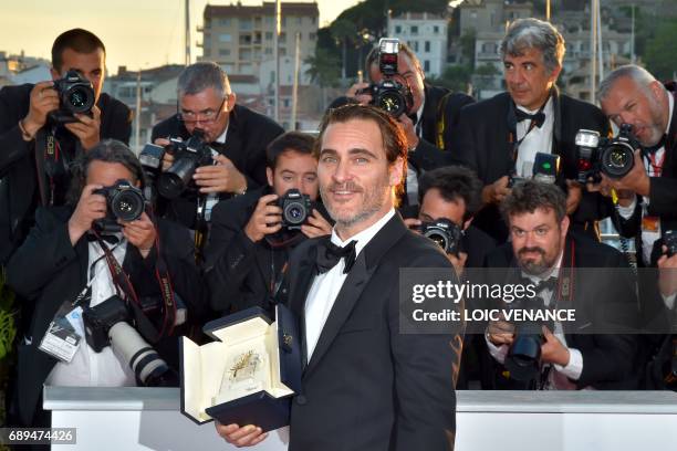 Actor Joaquin Phoenix poses on May 28, 2017 during a photocall after he won the Best Actor Prize for 'You Were Never Really Here' at the 70th edition...