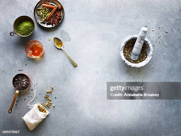 overhead still life of teas and spices - chamomile tea bag stock pictures, royalty-free photos & images