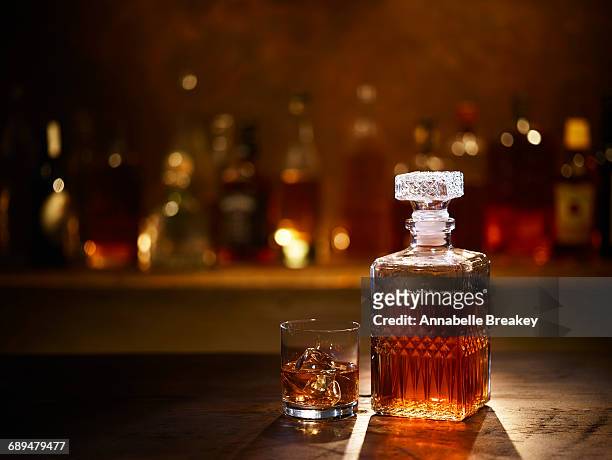 still life of bourbon whiskey on bar - whiskey stock pictures, royalty-free photos & images