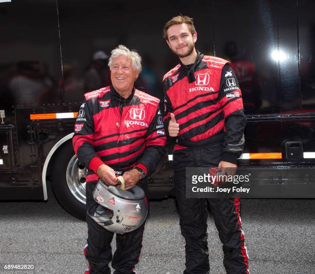 Mario Andretti and DJ/Musician ZEDD pose for a photo moments after taking a parade lap in a doubleseater Indy car together during the 101st...