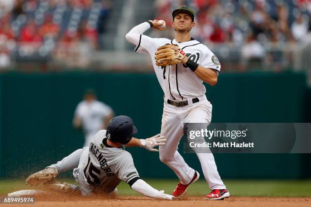 Trea Turner of the Washington Nationals attempts to turn a double play over Cory Spangenberg of the San Diego Padres for the second out of the eighth...