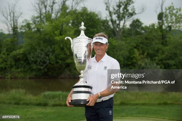 Champion, Bernhard Langer of Germany, poses for a photo with the Alfred S. Bourne Trophy during the 78th KitchenAid Senior PGA Championship at Trump...