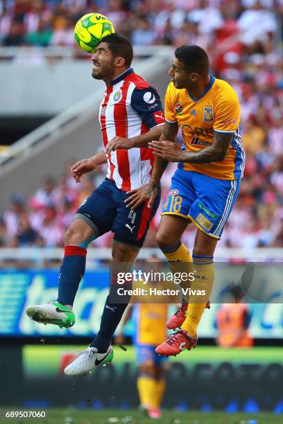 Ismael Sosa of Tigres jumps for the ball with Jair Pereira of Chivas during the Final second leg match between Chivas and Tigres UANL as part of the...