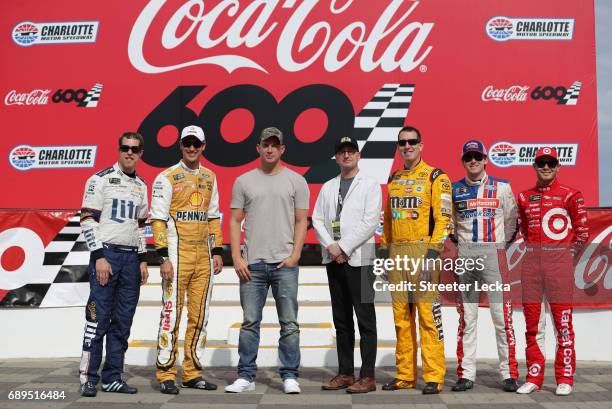 Actor Channing Tatum and director Steven Soderbergh stands on with Brad Keselowski, driver of the Miller Lite Ford, Joey Logano, driver of the Shell...